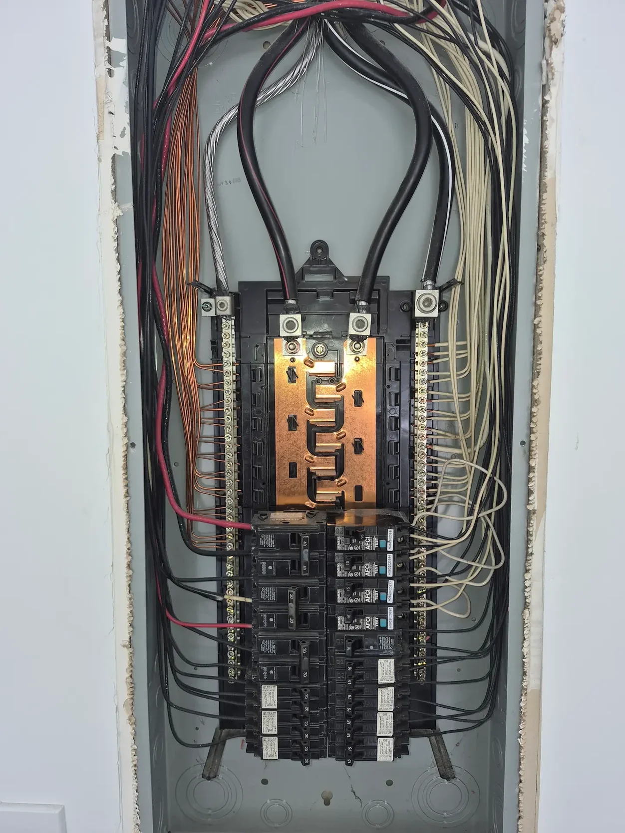 Electrician troubleshooting a tripping circuit breaker in Monroe Georgia