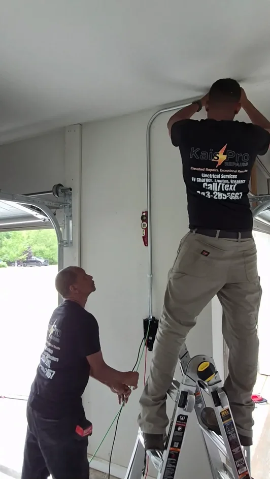Kais Pro Repairs technicians installing a protected wiring route in a garage