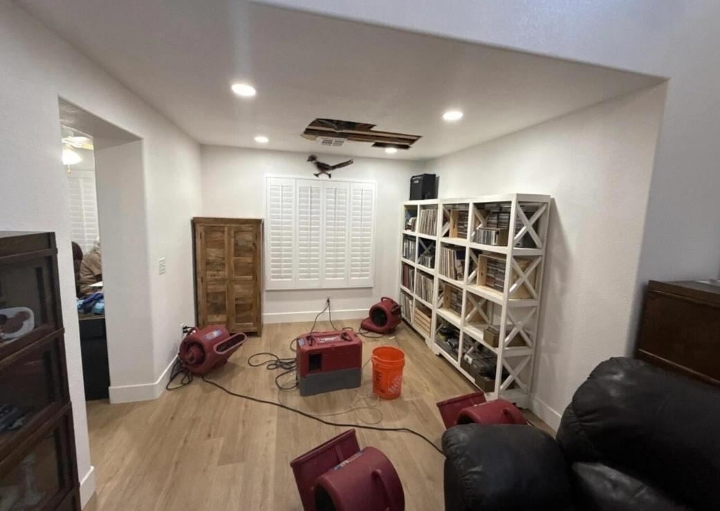 Drying equipment set up in a water-damaged living room