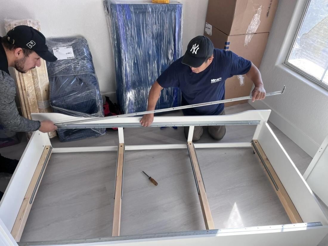 VIP crew reassembling furniture after a pack-back