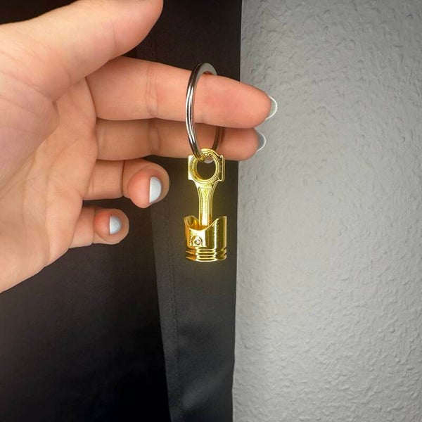 Kolben Schlüsselanhänger in gold