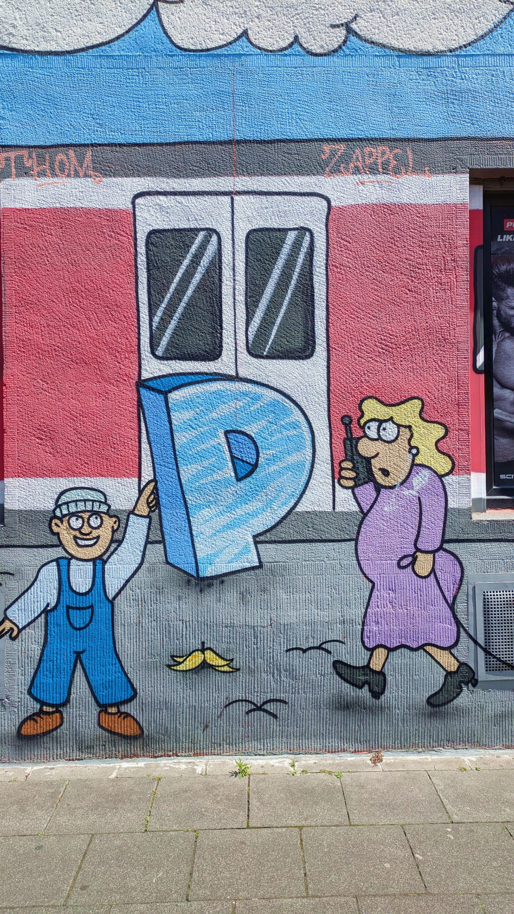  Comicartige StreetArt mit einem Mann und einer Frau – Wandbild in Nippes