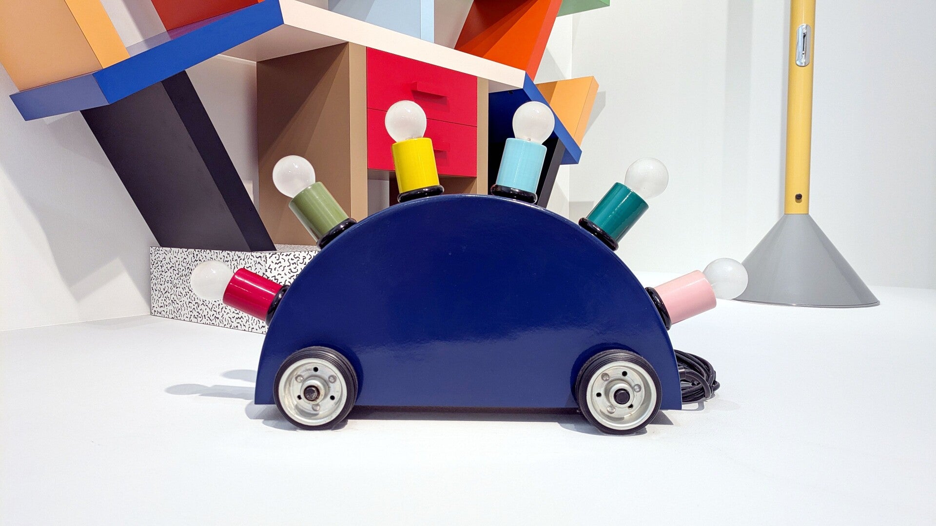 Eine bunte Lampe in Form eines Holzautos im Museum MAKK