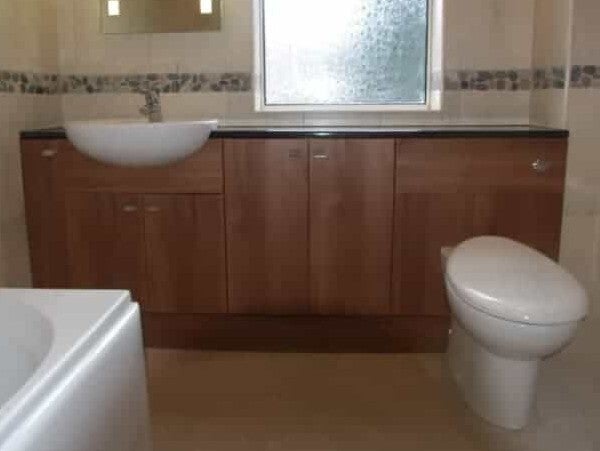 Refurbished bathroom featuring a ste of base units with back to wall toilet, sit-on basin, bath ans tiled walls. North Ferriby