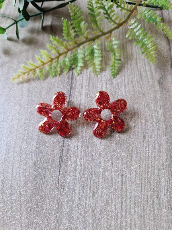 Boucles d'oreilles fleur en résine rouge pailletée.