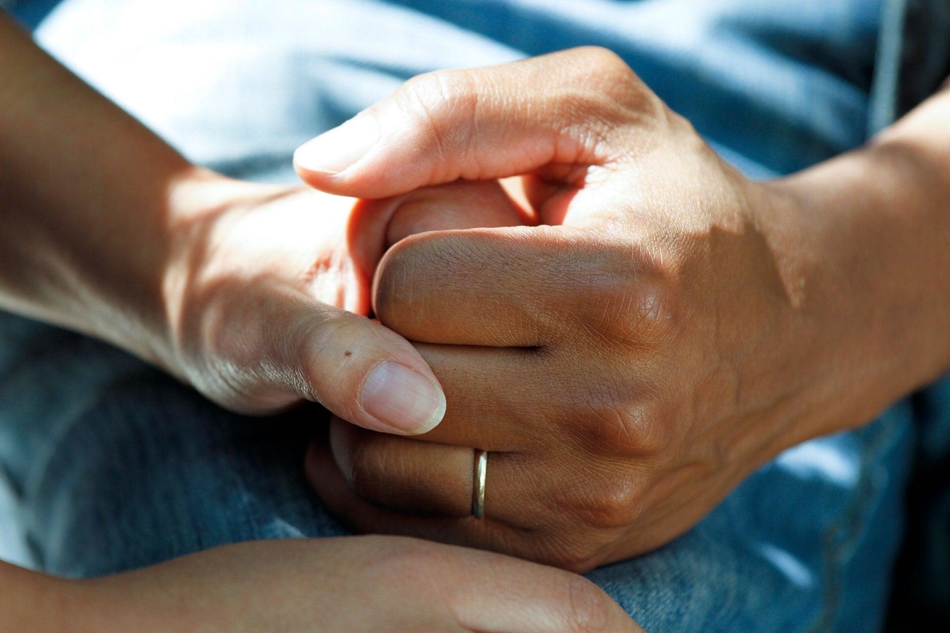 Caregiver holding a resident's hand in companionship