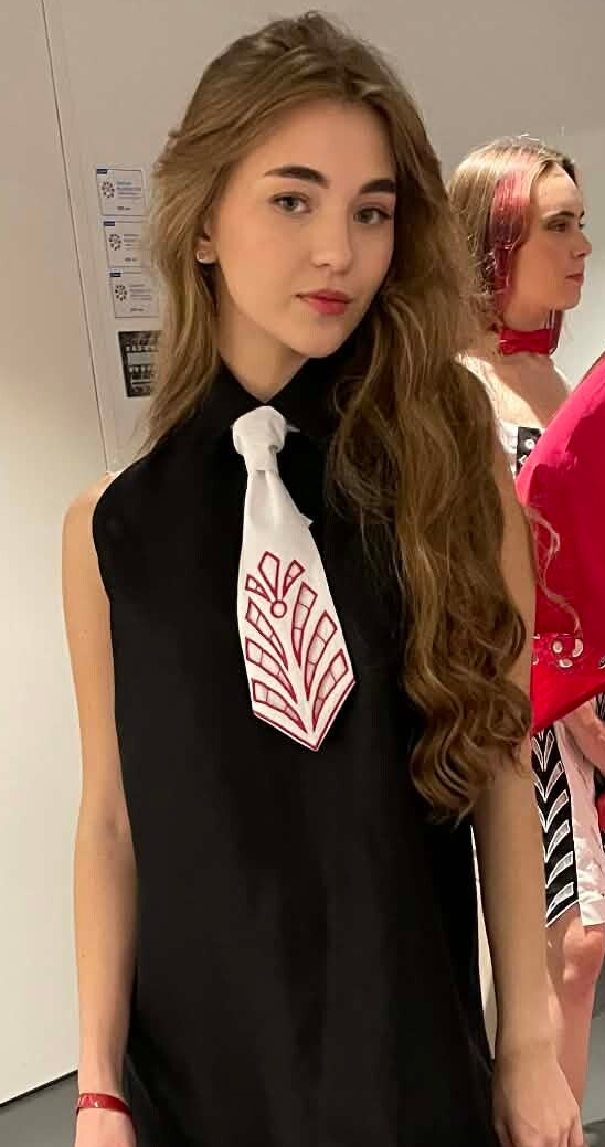 Black dupioni silk dress. Short sleeveless with collar & white tie with cut out embroidery