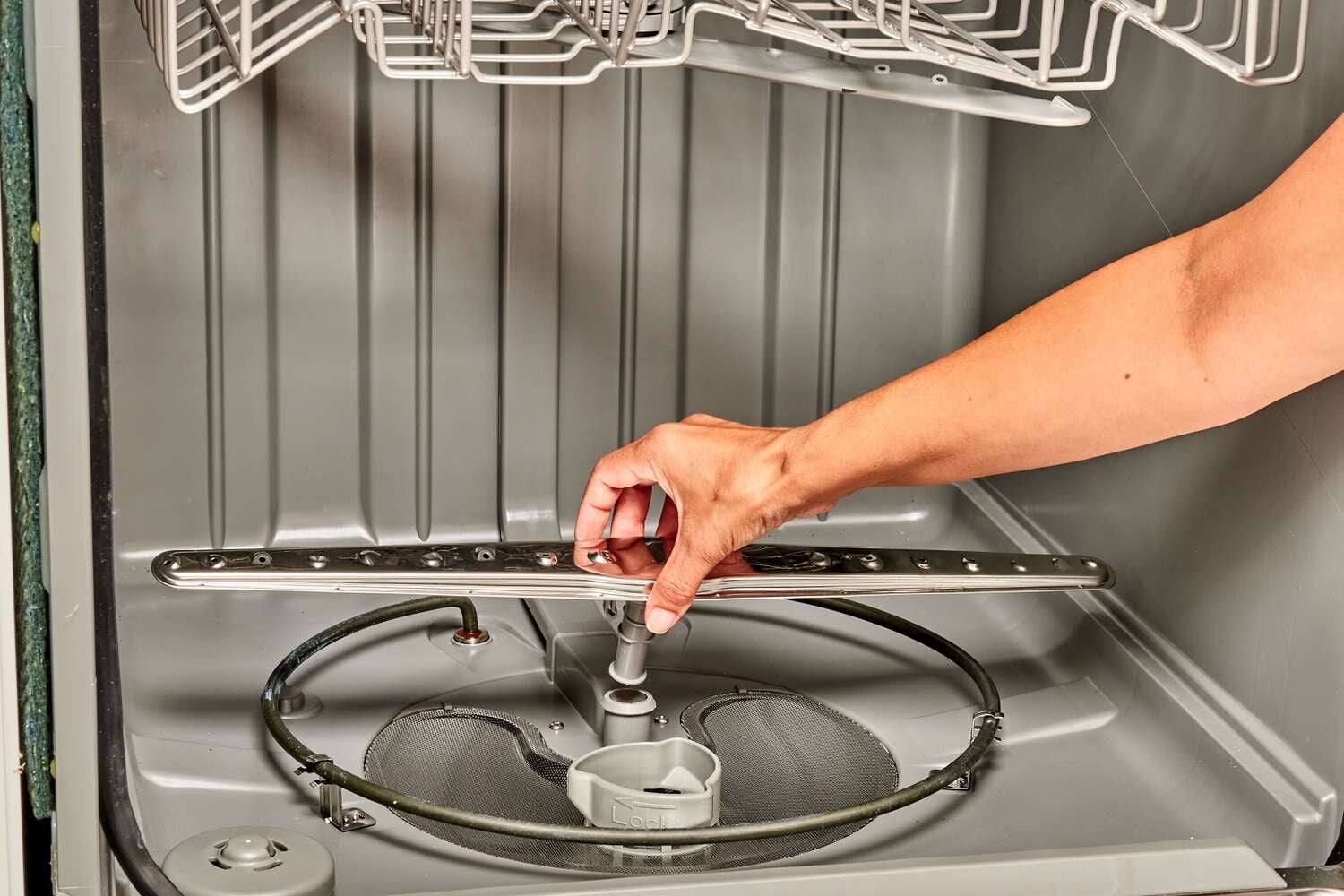 Appliance technician repairing dishwasher 