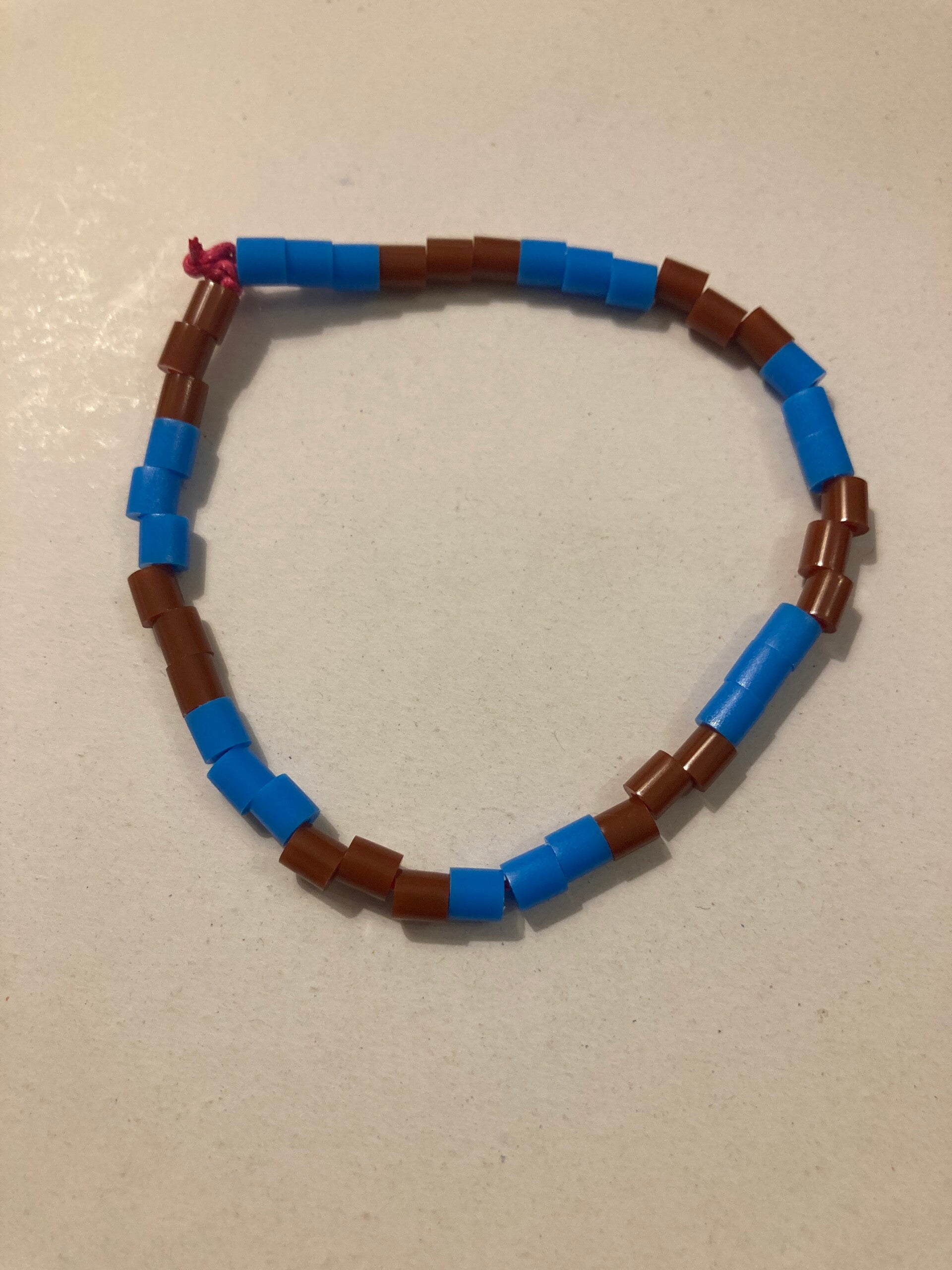BRACELET Blue And Brown Plastic Beads On Pink Cord