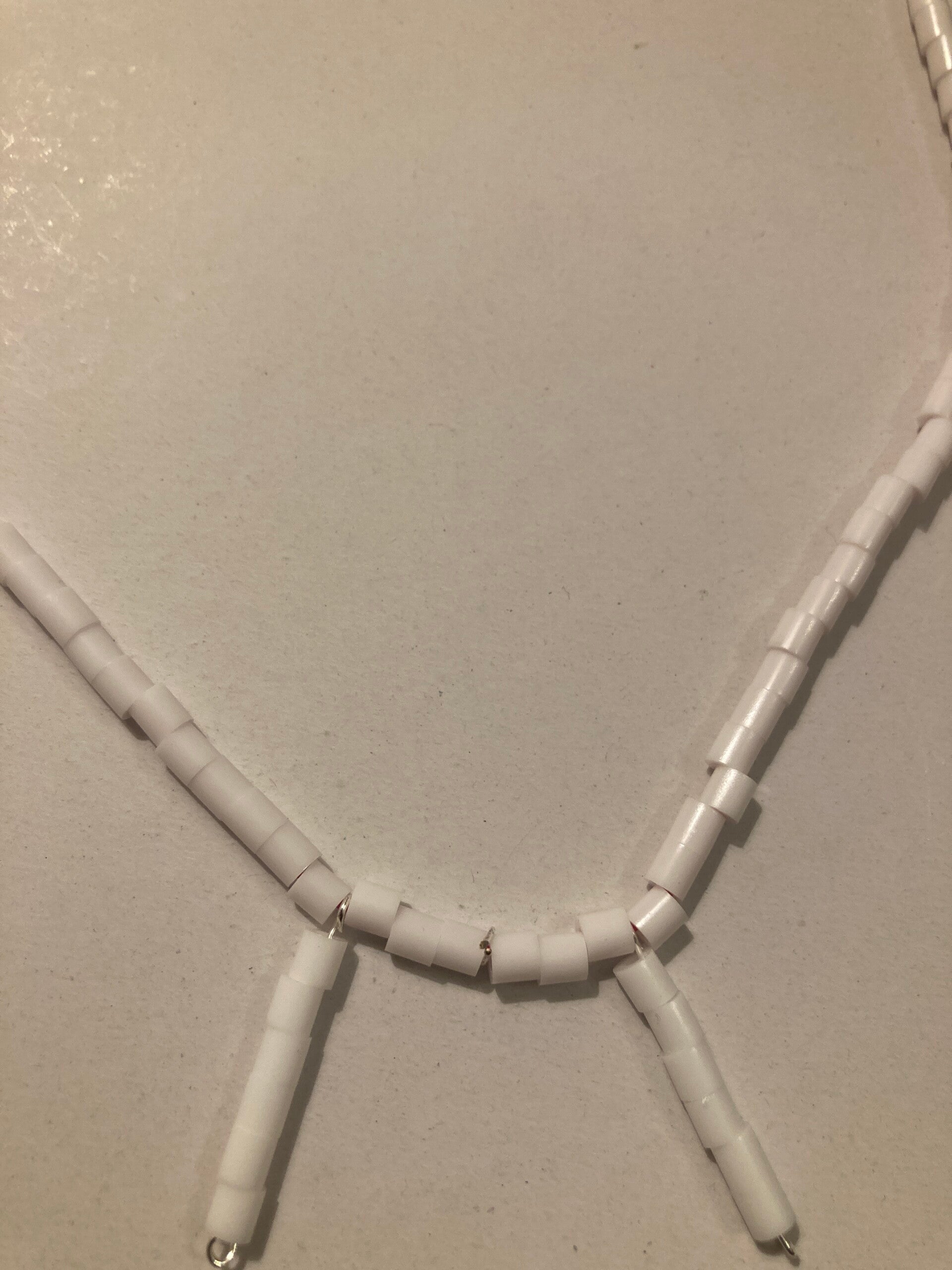 MATINEE NECKLACE White Plastic Spacer Beads And Silver Plated Fastenings On Pink Cord