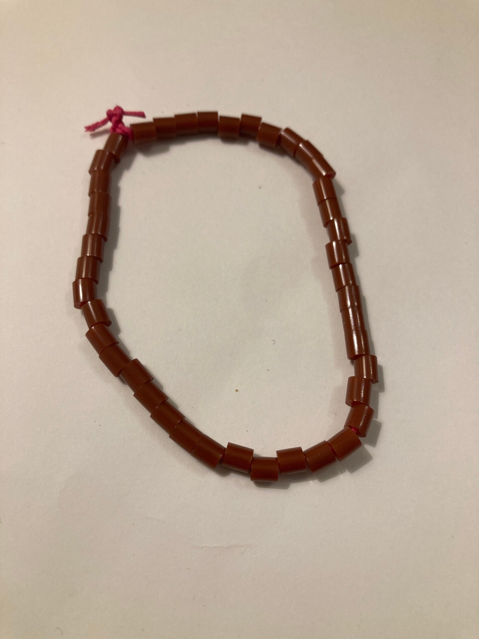 BRACELET Tan Brown Plastic Spacer Beads On Pink Cord