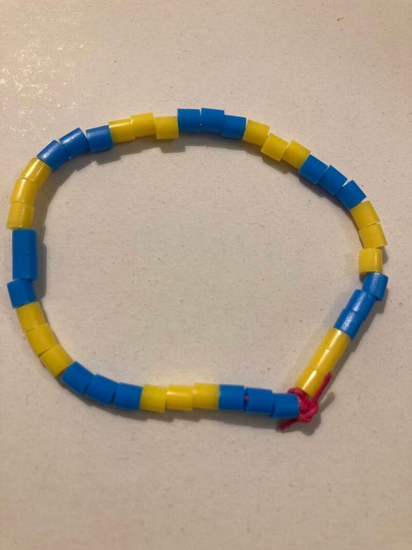 BRACELET Yellow And Blue Plastic Spacer Beads On Pink Cord