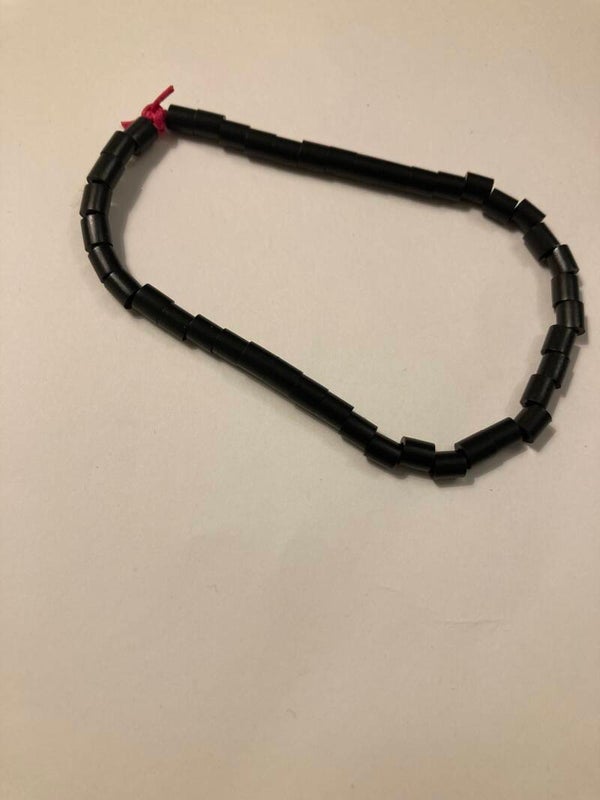 BRACELET Black Spacer Beads On Pink Cord Plastic Beads