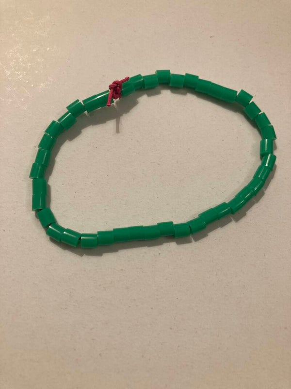 BRACELET Green Plastic Tube Beads On Pink Cord