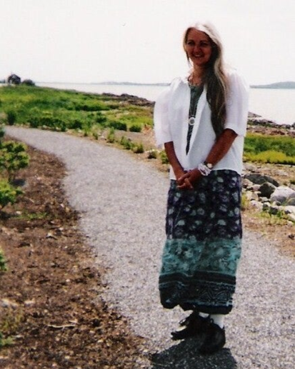 Johanne Maltais sur un chemin de gravier au bord de l'eau.