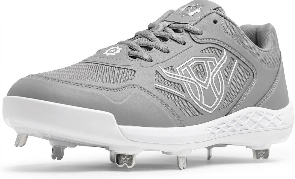 A low-angle, front-facing view of a Marucci CFT grey and white baseball cleat with metal spikes on a white background.