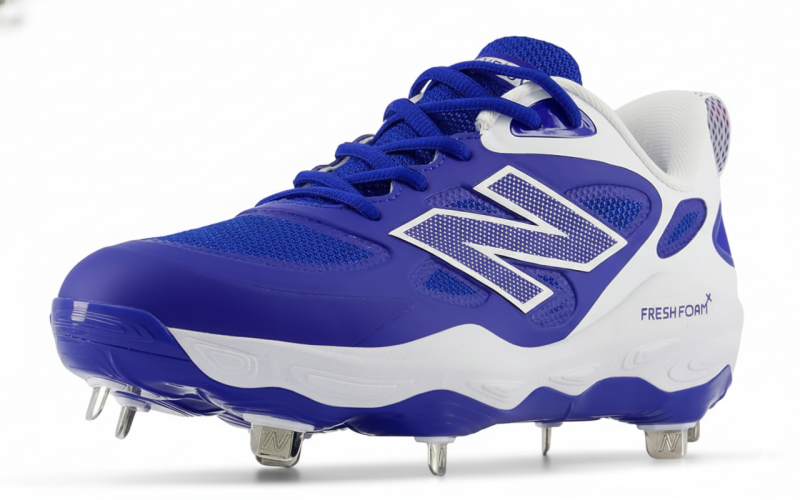 New Balance Women's Fresh Foam X Velo V4 Metal softball cleats with metal spike plate and Fresh Foam X midsole built for competitive fastpitch players on natural grass and dirt.