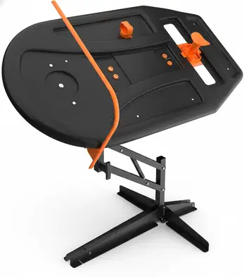 Swing path trainer with a black oval platform, orange guide arm, and adjustable metal stand on a white background.
