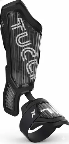 TUCCI Verona batter's leg guard in black with transparent hard-shell panel, TUCCI branding, and ankle strap system.