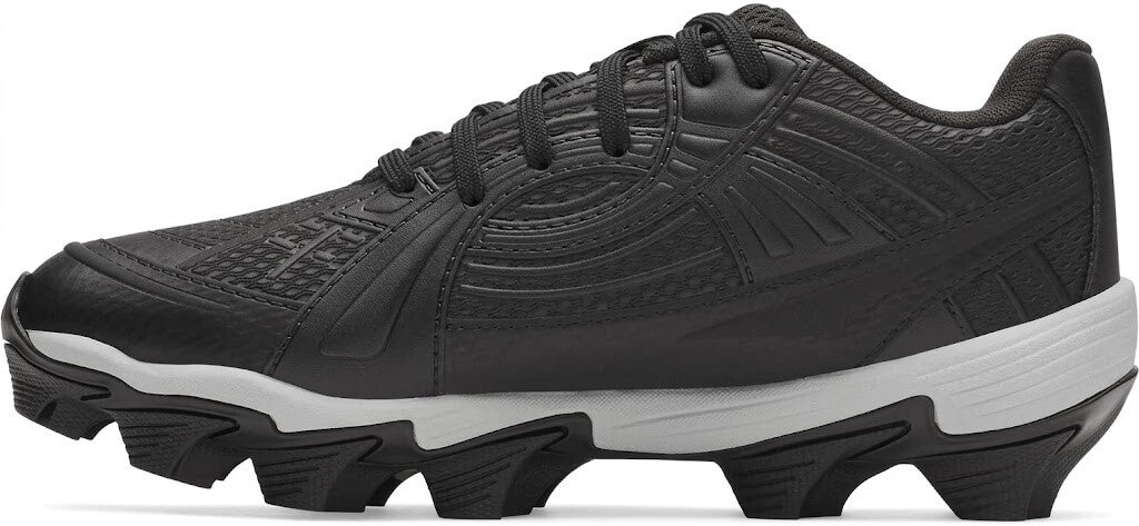 A black softball cleat with a textured synthetic upper and a thick white midsole featuring aggressive black molded studs.