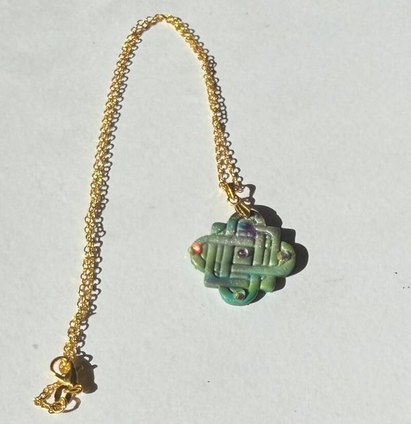 Embossed knot style pendant