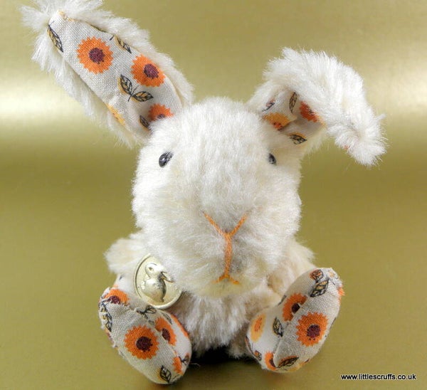 Bunty, a fluffy rabbit with vintage orange flower fabric inner ears and paws