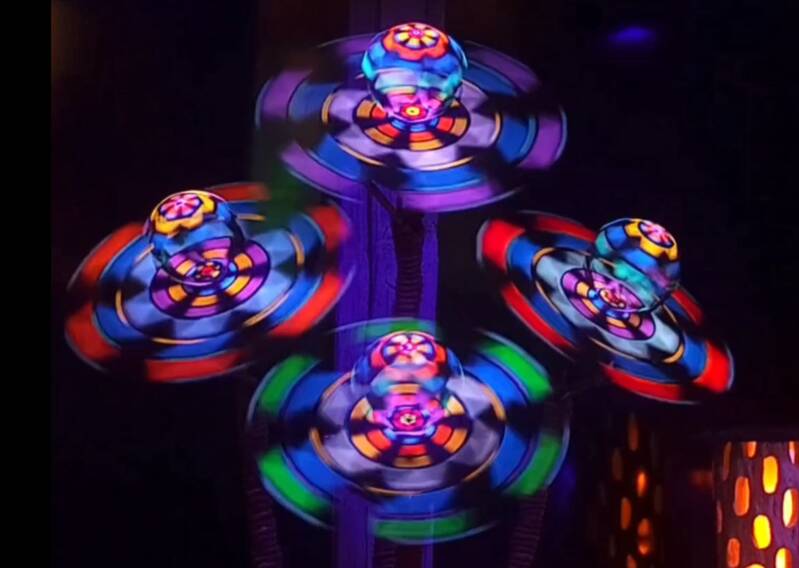 4 Cosmic Flowers with Fluorescent Rotating Geometric Discs with 3D Geometric Globe Centers. Luminous Purple, Pink, Blue, Green, Turquoise and Silver Colors and Patterns.