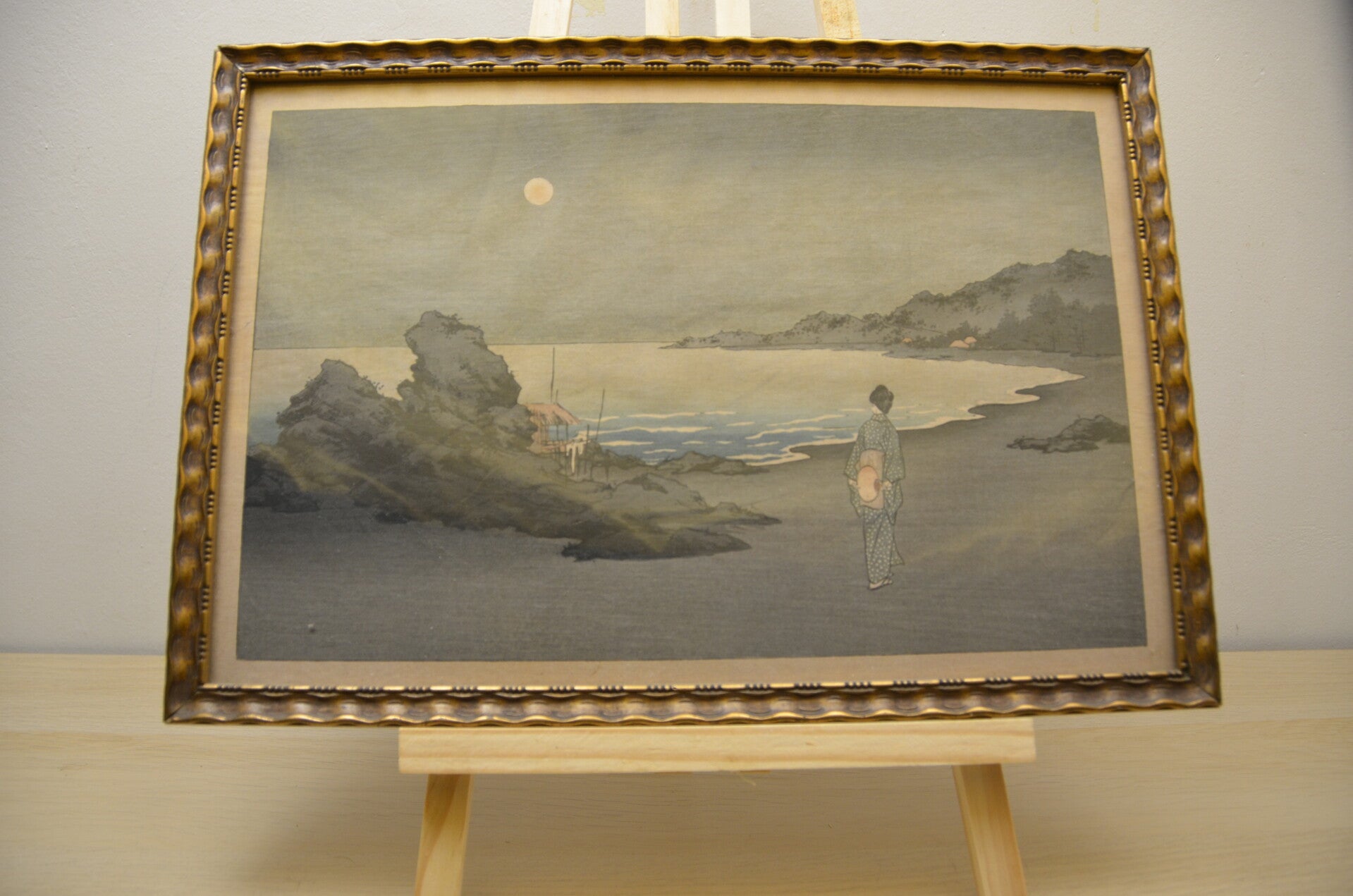A woman sauntering on a beach by moonlight