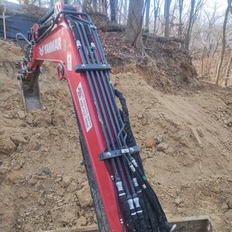 mini excavator operation for retaining wall installation