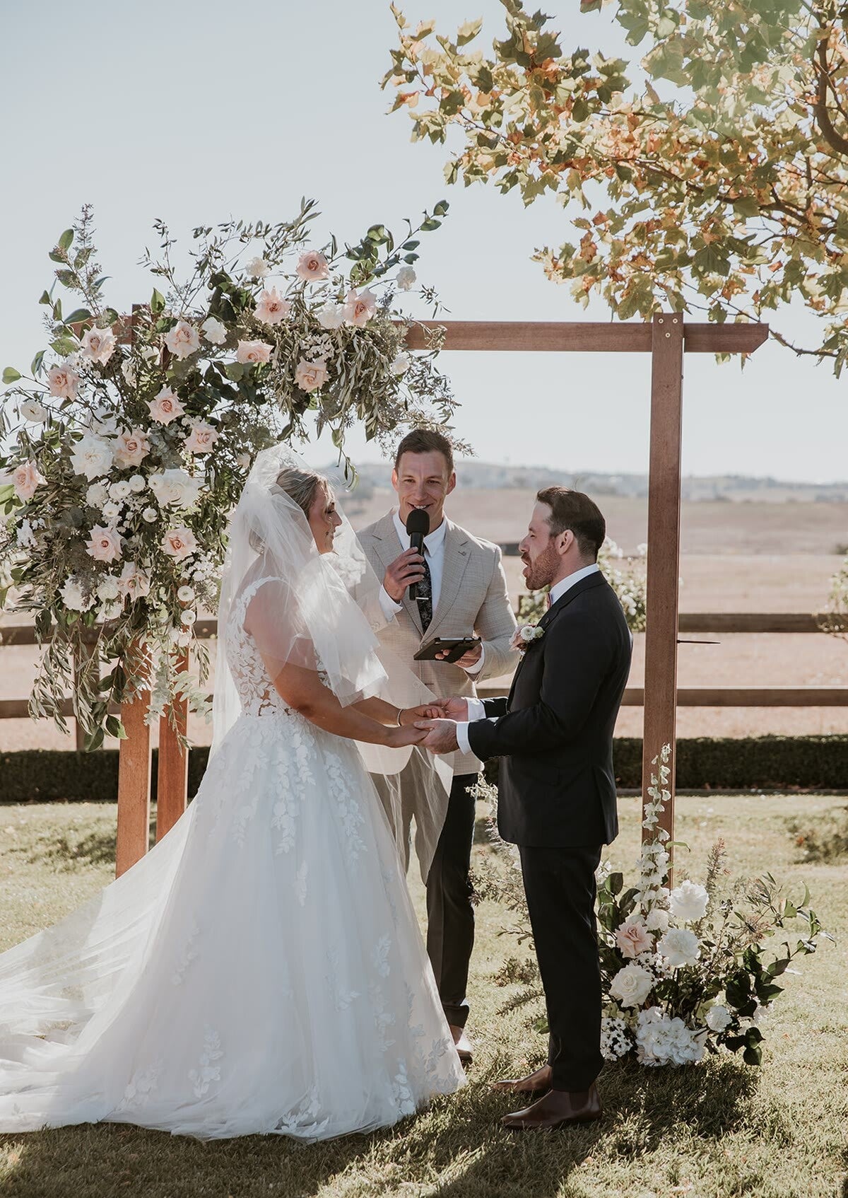 Adam and Chelsea exchanging vows with Riley Farlow at BoxGrove Estate