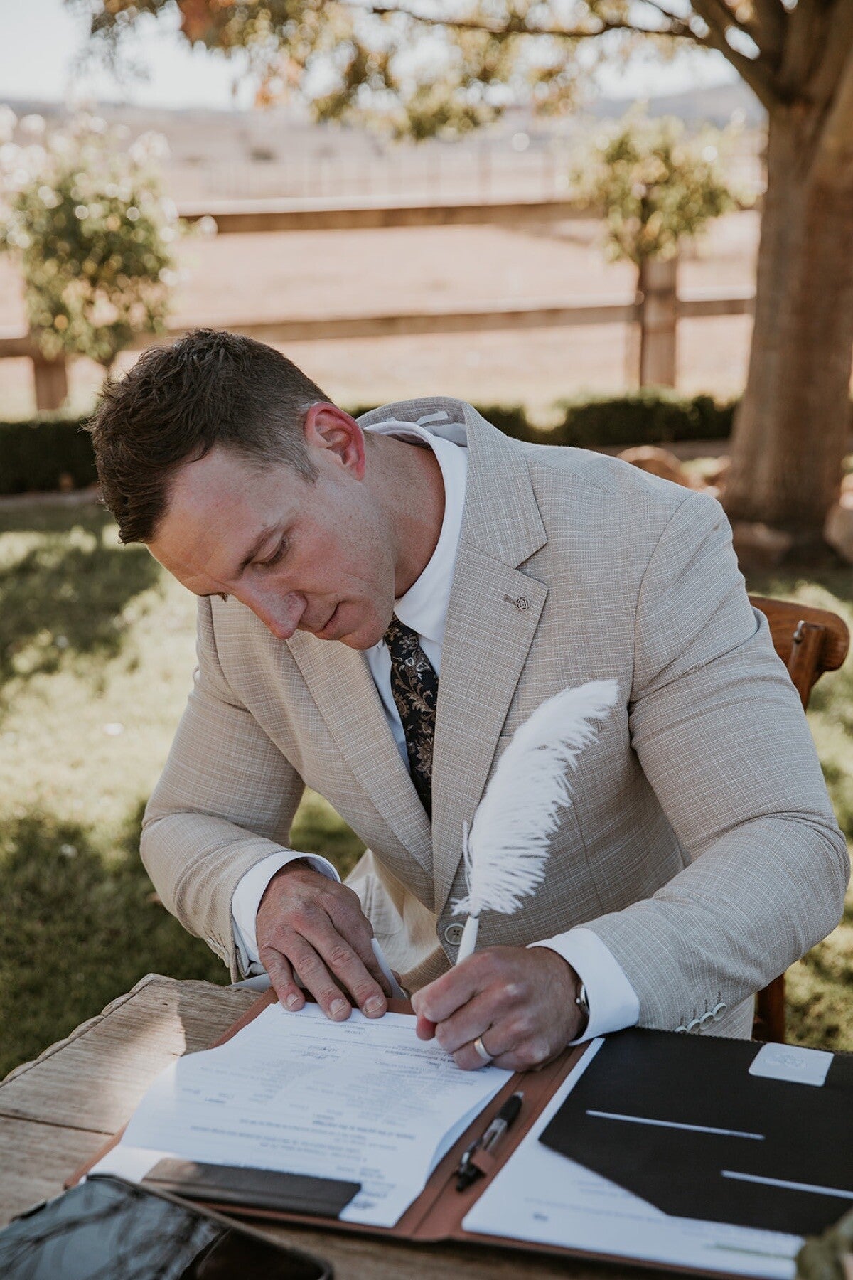 Riley Farlow signing Adam and Chelsea’s marriage documents at BoxGrove Estate
