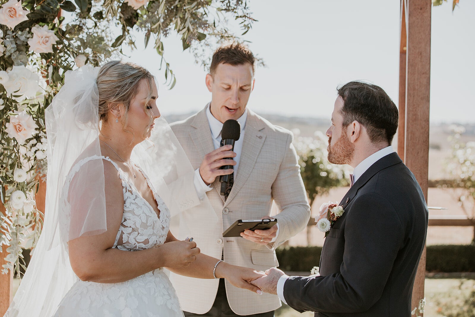 Marriage celebrant Riley Farlow leading an outdoor wedding ceremony in Penrith