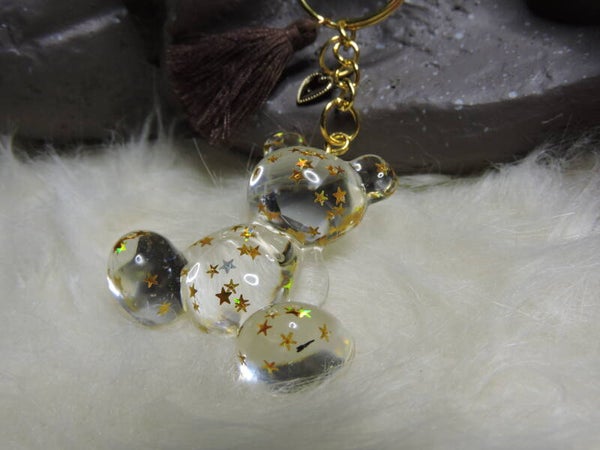 porte clés ourson transparent avec étoiles dorées