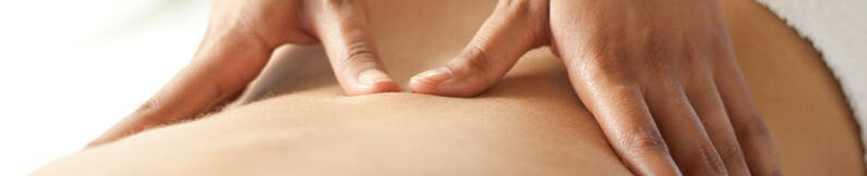 Hands on a back performing relaxing massage