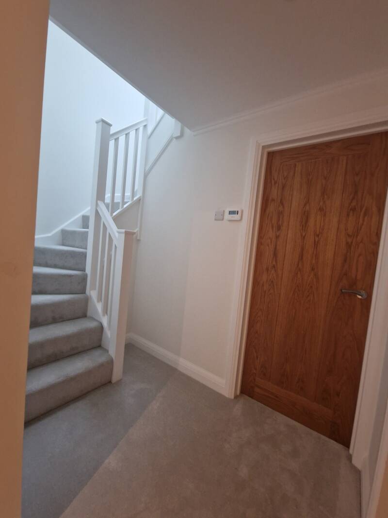 Oxted carpenter | Timber internal door beside a finished staircase | Oak & Stone Oxted carpenter – Timber internal door beside a finished staircase
