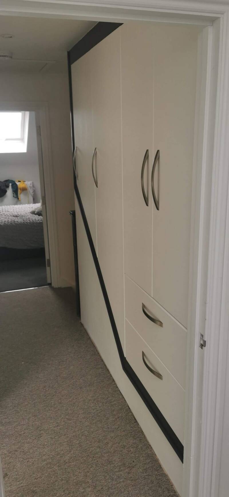 Bespoke above-stairs cupboards with drawers in an East Grinstead home