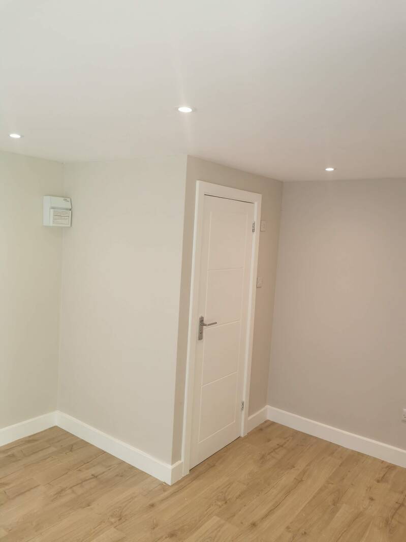 Garden room interior in East Grinstead with timber-effect flooring and recessed lights