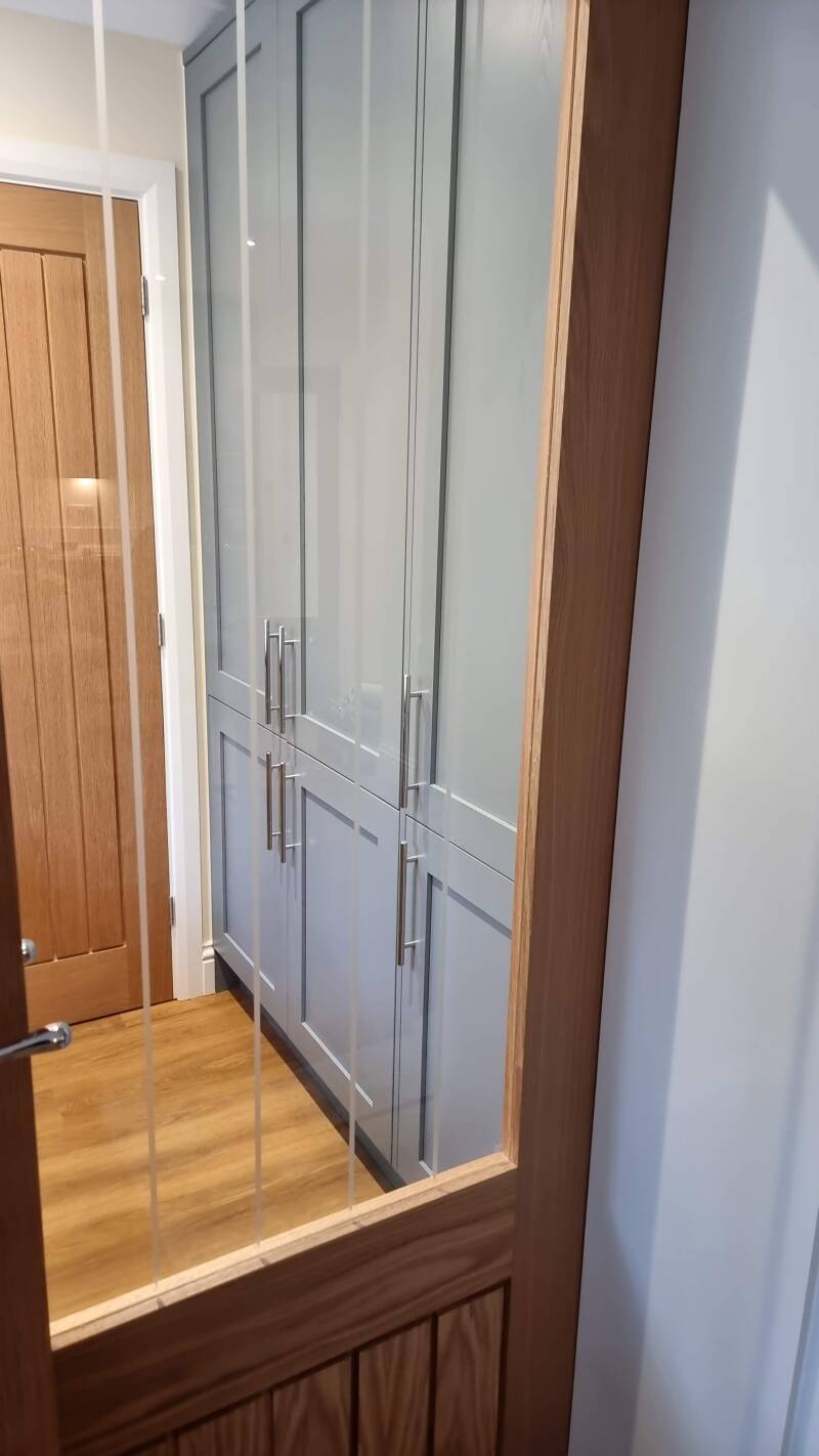 Oxted carpenter – grey fitted wardrobes beside a mirrored timber door by Oak & Stone