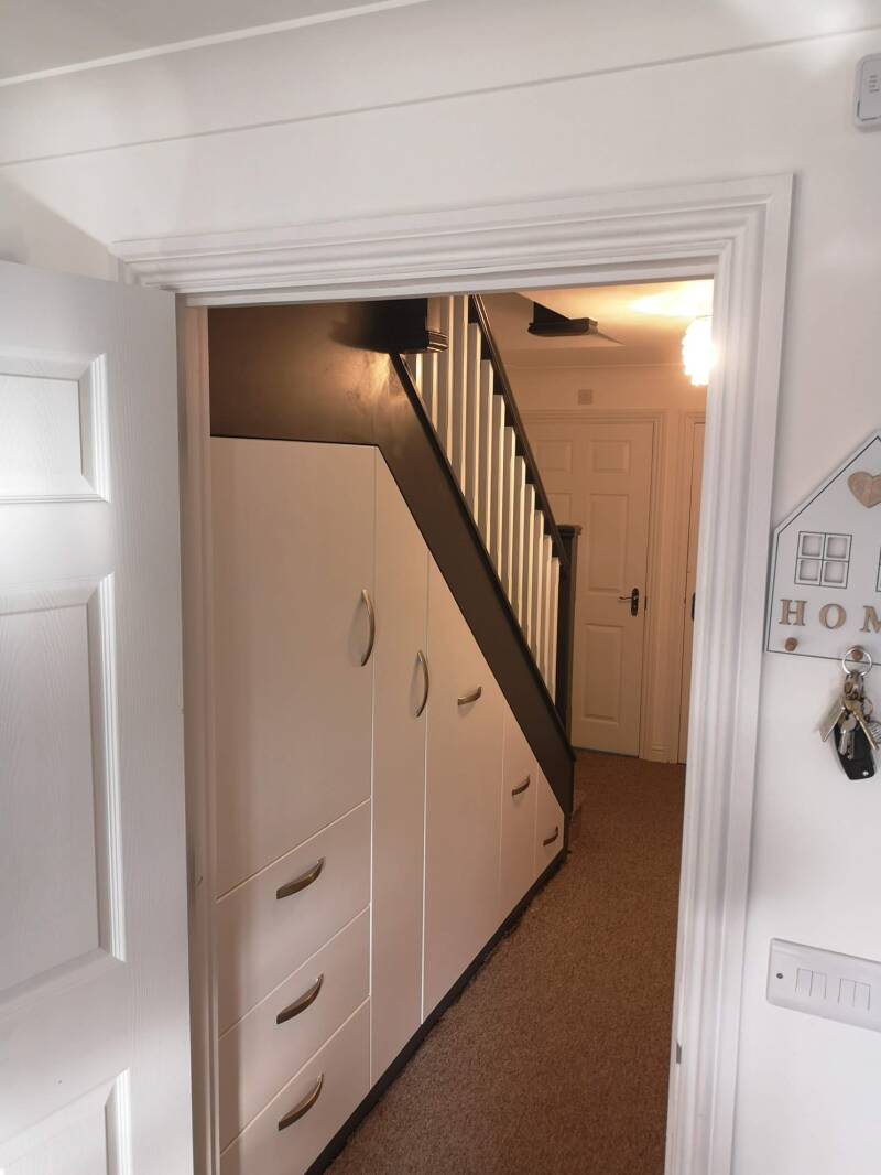 Bespoke understairs cupboards fitted beneath a staircase in East Grinstead