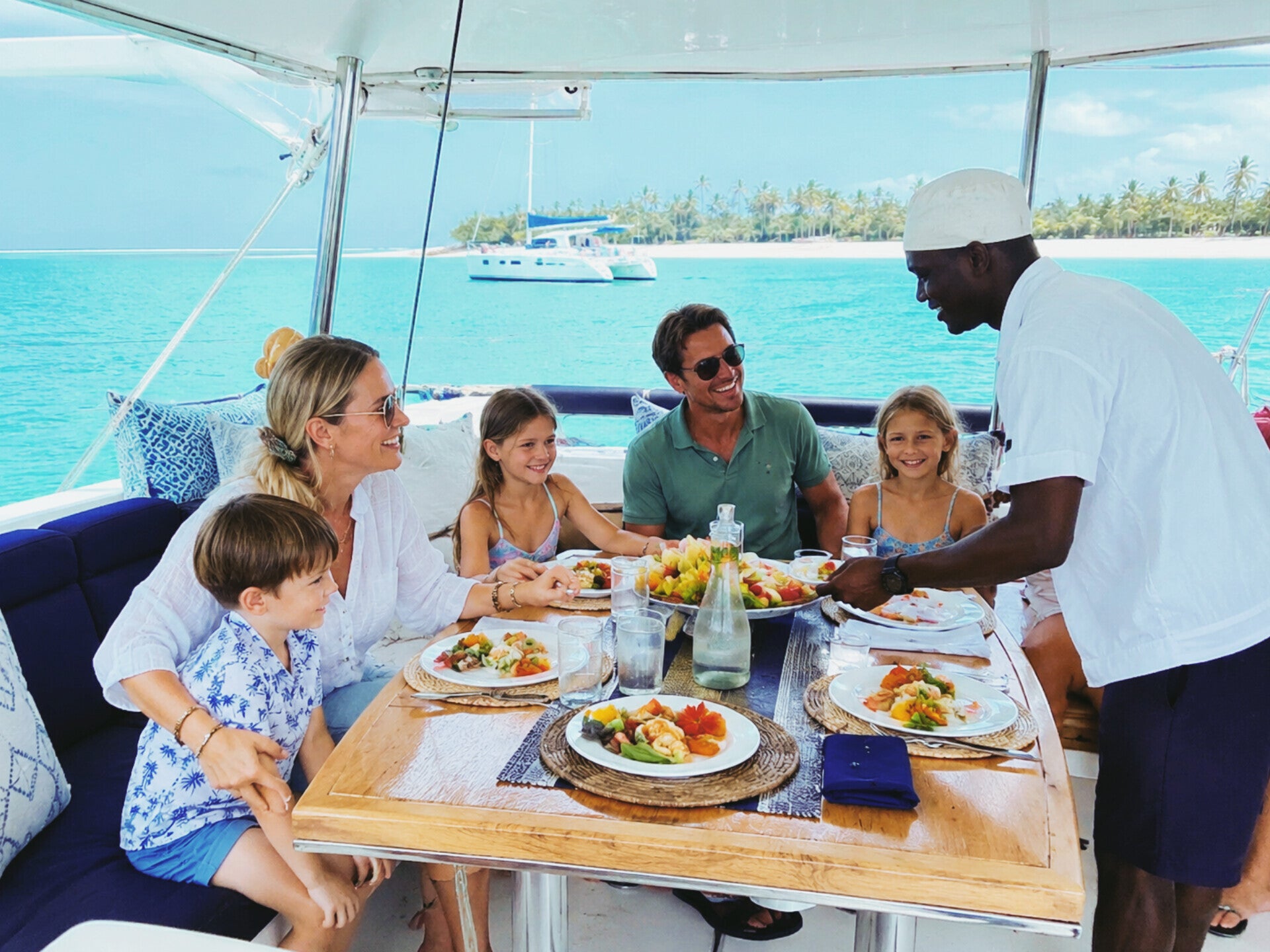 Family enjoying a fully crewed catamaran charter with a private chef in Zanzibar
