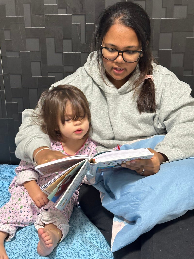 Joy reading with her daughter