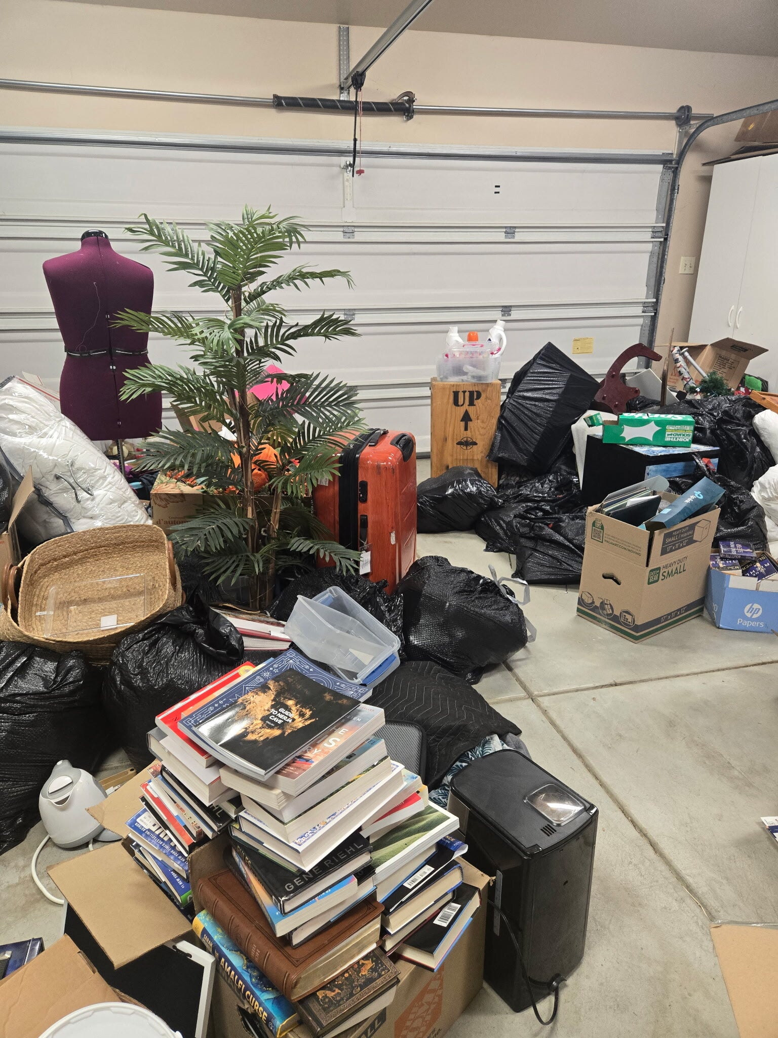 Pile of assorted junk and debris, including boxes, bins, toys, and household waste, ready for removal by DBM Hauling in El Cajon, California.