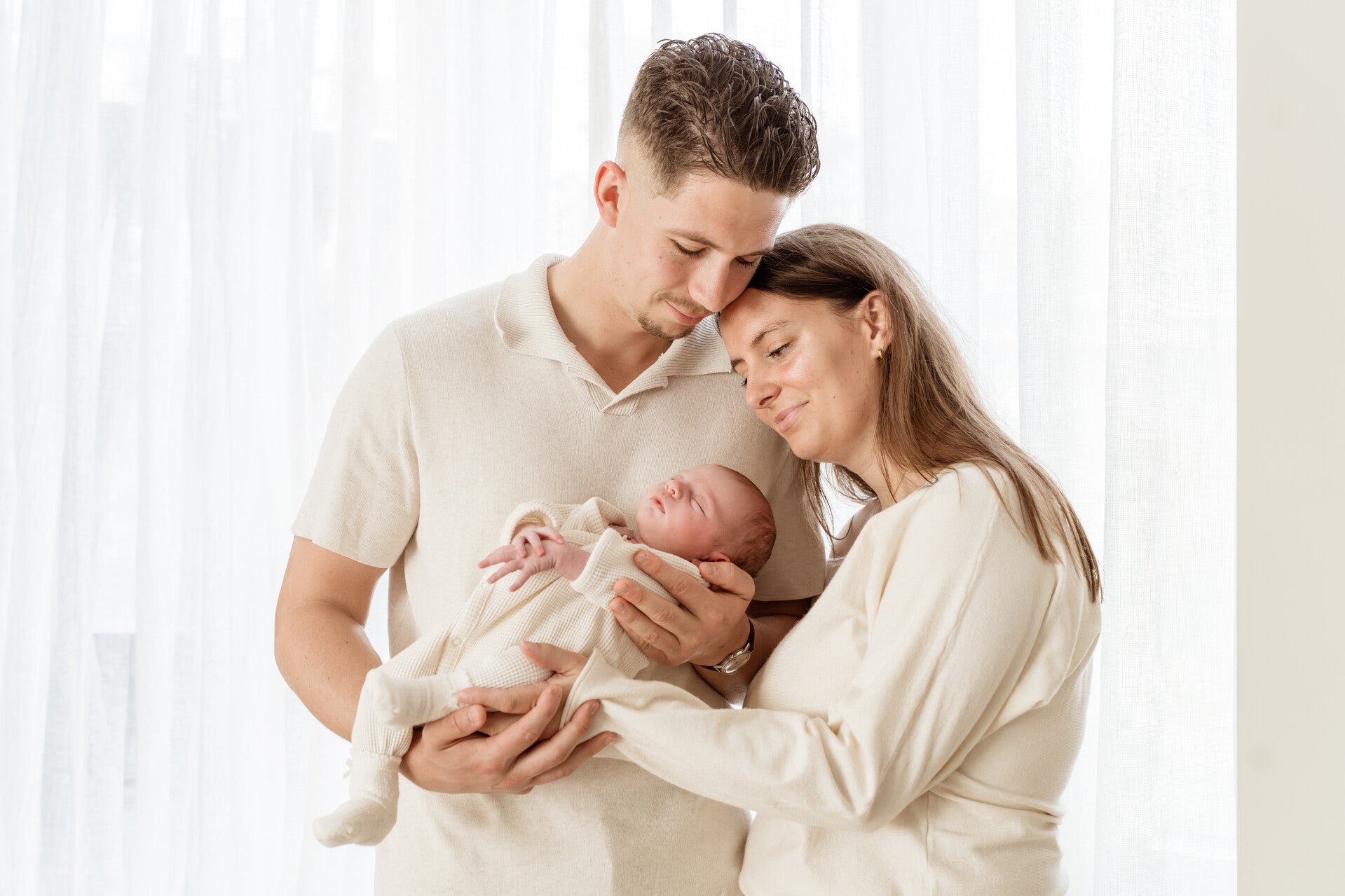 Kleine baby in de armen van moeder met natuurlijk daglicht
