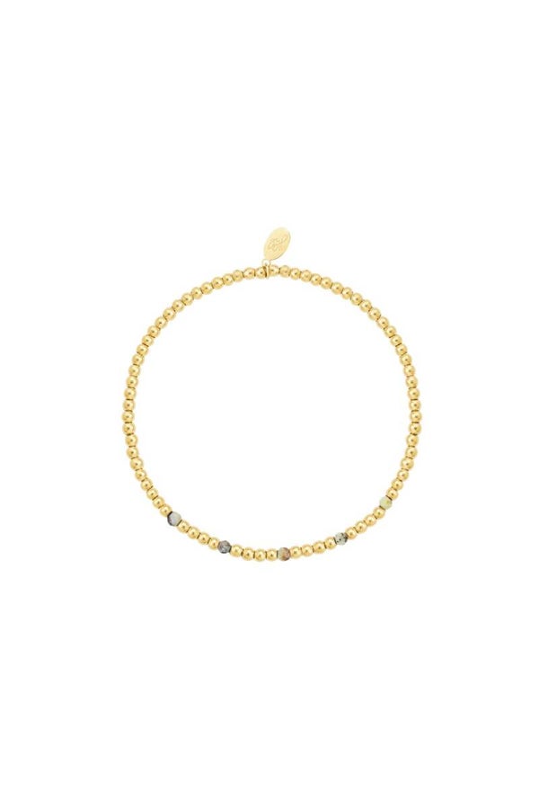 Golden armband met groene steentjes