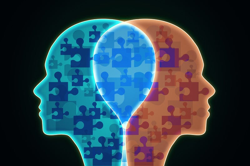 Zwei Köpfe mit Puzzelteilen in blau und rot, im Kontext mit Jenseitskontakte Jana Lorenz Blog.