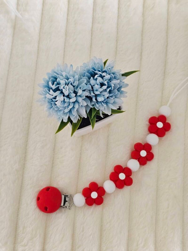 Attache tétine fleur rouge