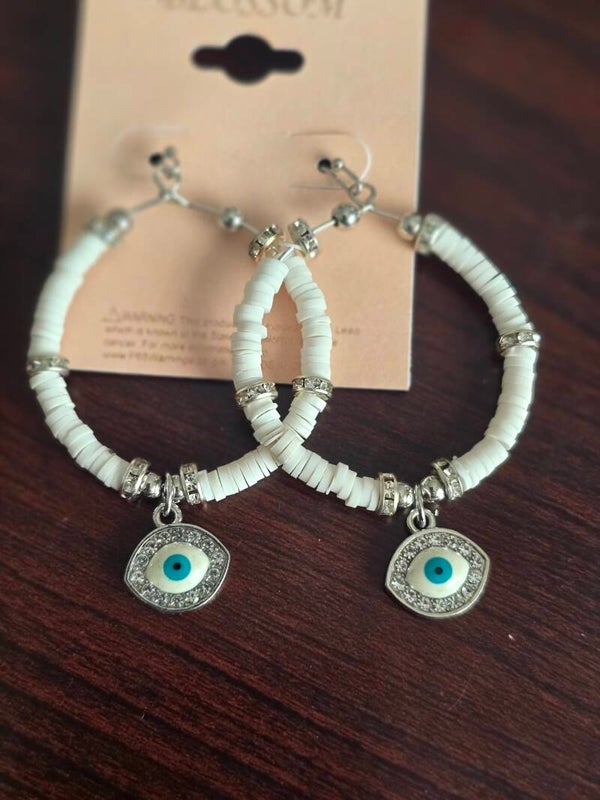 White evil eye earrings on silver backing