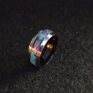 R17 Size 8. Stainless steel comfort fit unlay ring, black core. 4 opals , and a mix of fluorite, ruby flake and glow stone. UV reactive.