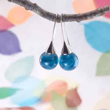 Trompet oorbellen met staal-blauwe glasbolletjes