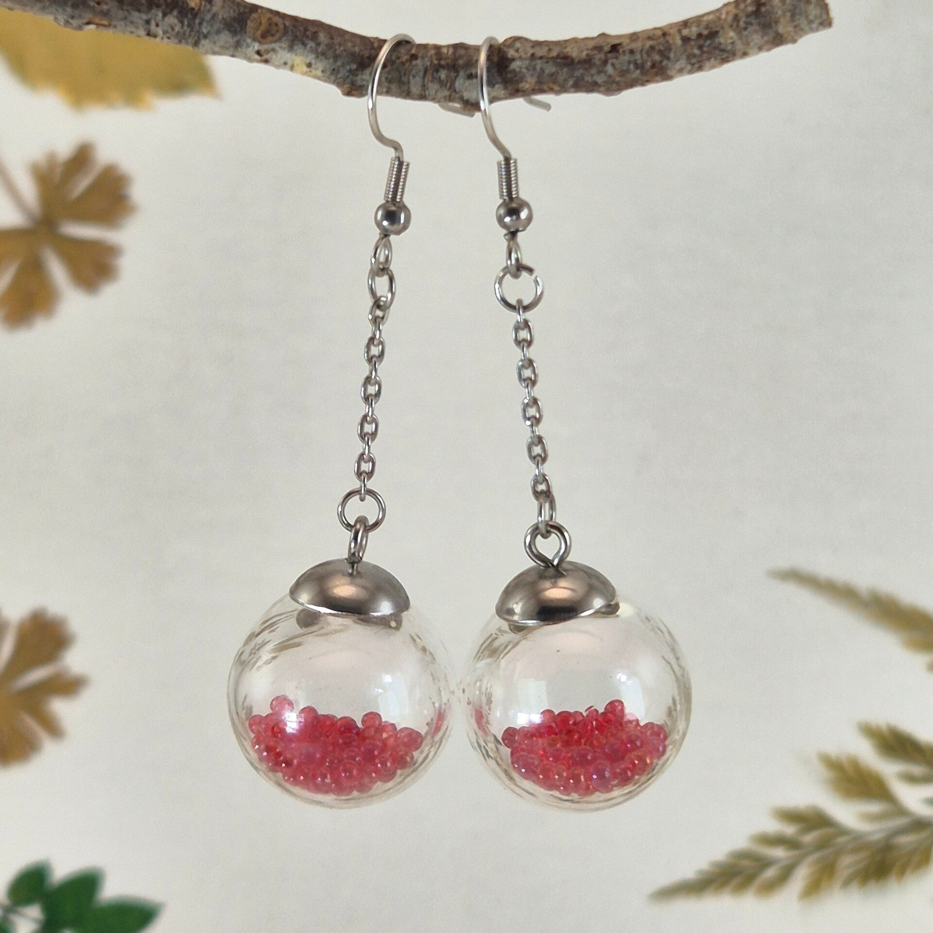 Oorbellen, geblazen bollen, transparant helder glas met fel-roze bolletjes